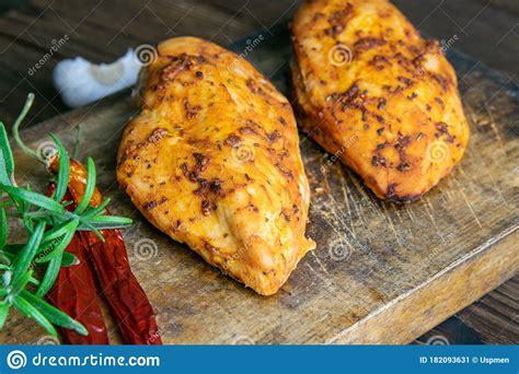 Spicy Baked Chicken Breast With Peper Rosemary An Garlic On Wooden