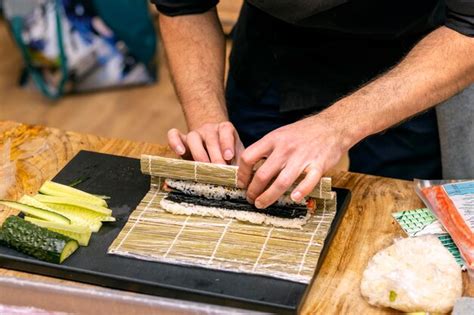 Premium Photo Cook39s Hands Closeup A Male Chef Makes Sushi And Rolls