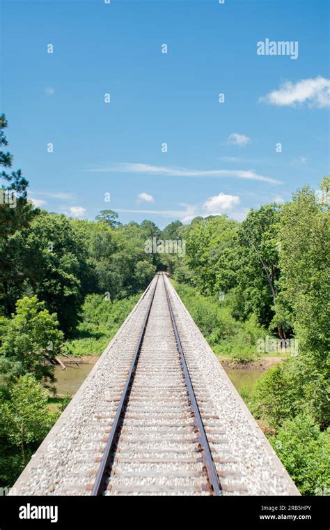 Rail road train tracks over a bridge Stock Photo - Alamy