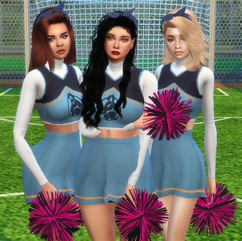 Three Female Cheerleaders Are Standing In Front Of A Soccer Goal With