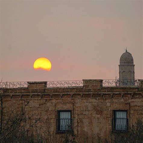 The Sun Is Setting Over An Old Building