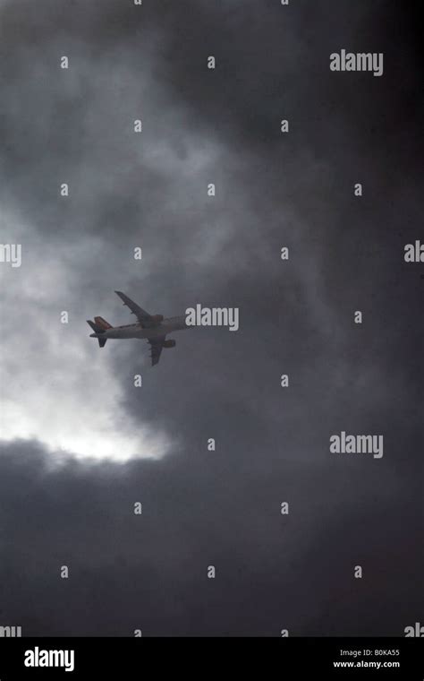 Easyjet Plane Flying Through Dark Clouds In Sky Stock Photo Alamy