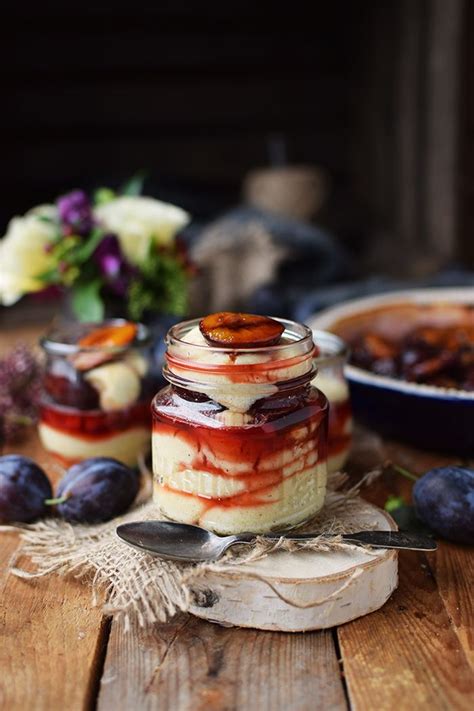 Two Jars Filled With Food Sitting On Top Of A Wooden Table Next To