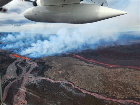 Aerial photos of lava flows moving downslope from fissures erupting on ...