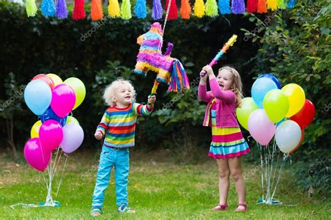 Kids playing with birthday pinata Stock Photo by ©FamVeldman 126903840