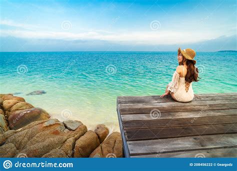 Happy Woman Sitting On A Wooden Bridge In Sea Beach At Koh MunNork