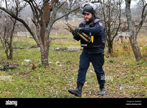 A Ukrainian Sapper Carries Unexploded Projectiles During A Demining