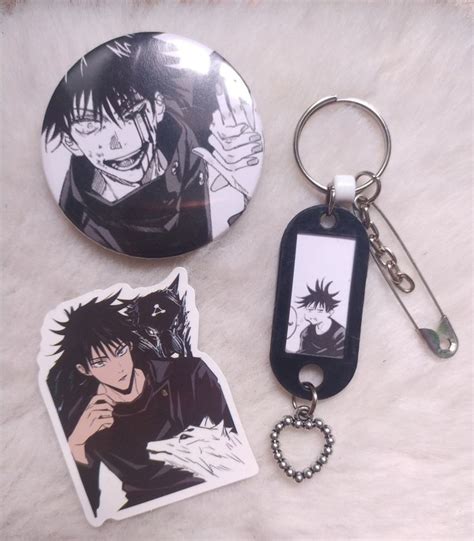 Two Keychains With Anime Characters On Them Sitting Next To Each Other