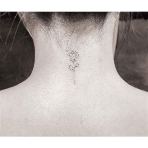 Fine Line Rose Tattoo Located On The Back Of The Neck