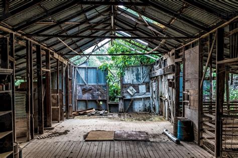 Image of Inside an abandoned farm shed - Austockphoto