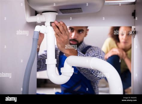 Woman Fixing Plumbing Under Sink Hi Res Stock Photography And Images