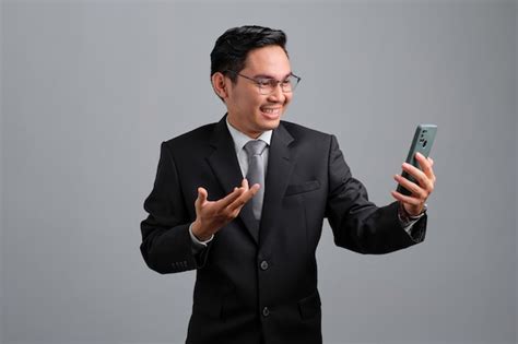 Premium Photo Portrait Of Cheerful Handsome Young Businessman In Formal Suit Using Smartphone