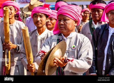 A Group Of Ethnic Minority Men In Traditional Costume Playing Music At