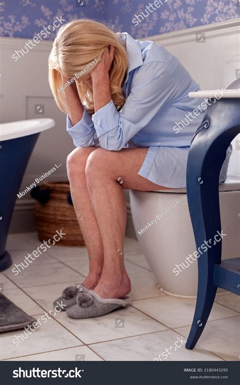 Menopausal Mature Woman Suffering Incontinence Sitting Stock Photo
