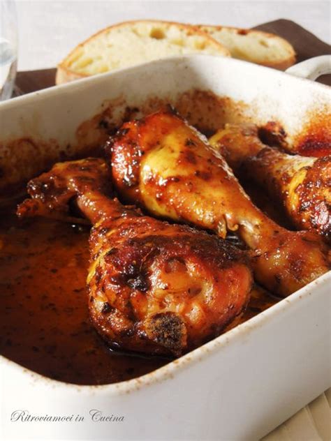 Chicken Wings Covered In Gravy Sitting In A Casserole Dish With Bread