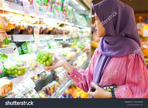 Happy Mature Asian Woman Looking Product Stock Photo