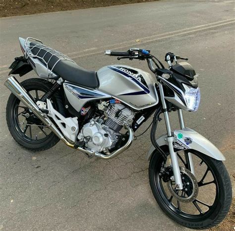 A Silver And Black Motorcycle Parked On The Street