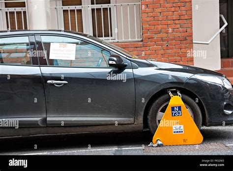 Immobilizer Wheel Clamp On The Wheel Of A Car Parked In A Prohibited