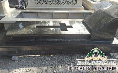 An Old Grave With Writing On It In The Middle Of A Cemetery Surrounded