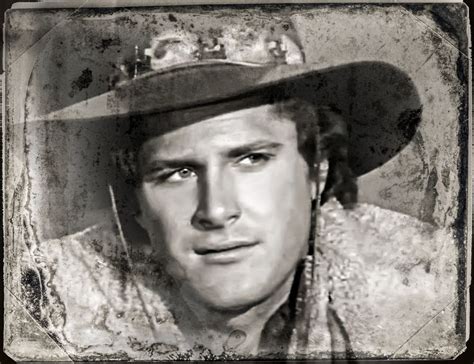 A Black And White Photo Of A Man Wearing A Cowboy Hat