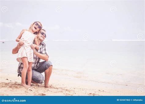 Pai E Filha Que Jogam Na Praia No Tempo Do Dia Foto De Stock Imagem