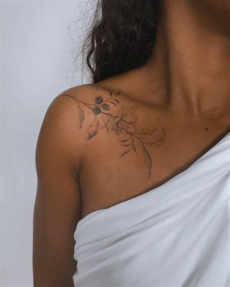 Lily Flower Tattoo Located On The Collarbone