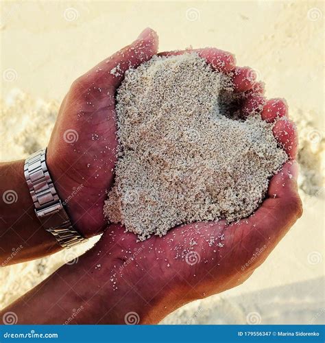 Men S Hands Hold White Sand In The Shape Of A Heart Stock Image