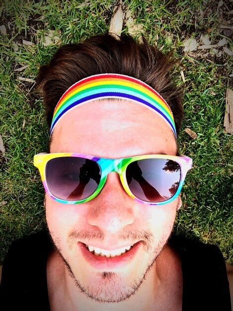 Premium Photo Portrait Of Smiling Man Wearing Colorful Sunglasses And Headband On Field