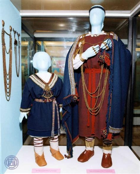 Museum display of the 11th century outfits of woman and child. In this ...