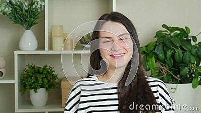 Happy Brunette Woman With Long Straight Hair Turns To The Camera And