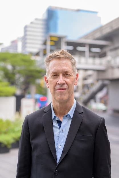 Premium Photo Portrait Of Mature Man Standing Outdoors