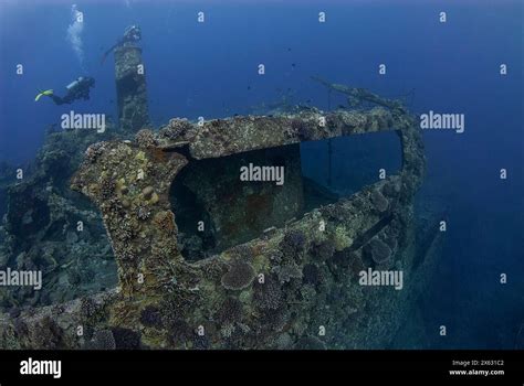 Scuba Diver Explores The Vast Serene Blue Of The Ocean Hovering