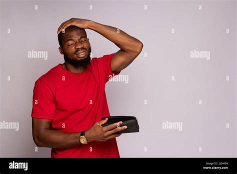 Broke African Man Holding An Empty Wallet Stock Photo Alamy