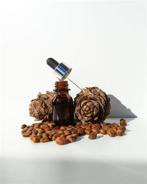 Cedar Essential Oil In Small Glass Bottles On A White Background Cedar