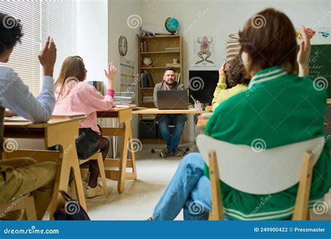 Confident Mature Teacher Of Anatomy Asking Questions To Highschool Students Stock Photo Image