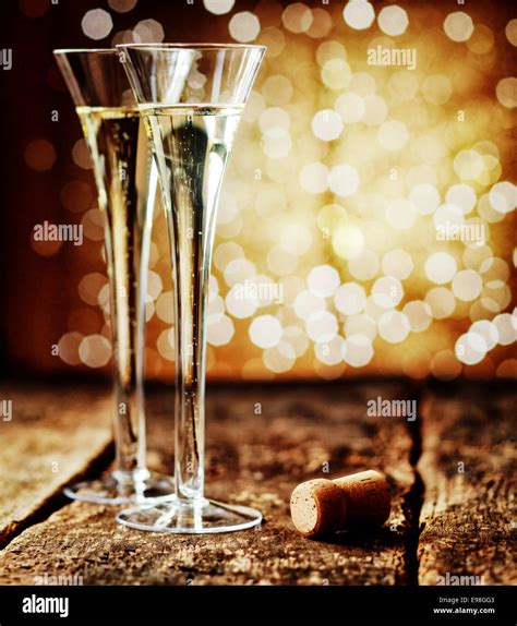 Two Tall Elegant Flutes Of Romantic Champagne On An Old Rustic Wooden