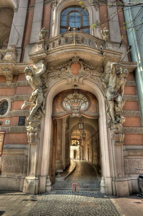 The Entrance To An Old Building With Statues On It