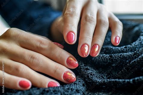 Woman With Beautiful Manicured Red Fingernails Gracefully Crossing Her