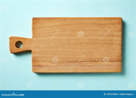 Wooden Cutting Board On Blue Background From Above Stock Photo Image