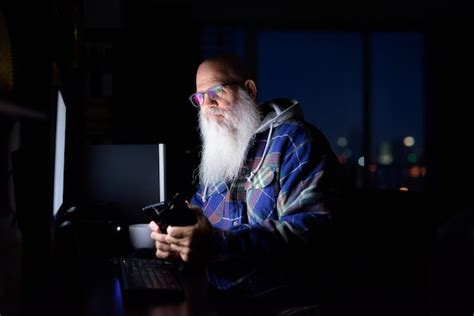 Premium Photo Mature Bald Bearded Hipster Man Thinking And Using