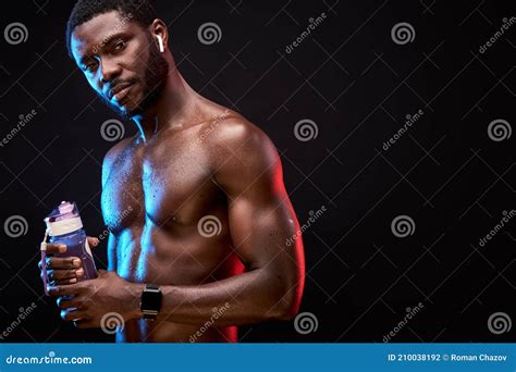 Portrait Of Athlete Black Male With Naked Torso Holding Water Bottle In Hands Stock Photo
