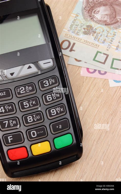 Credit Card Reader And Polish Currency Money On Wooden Desk Payment