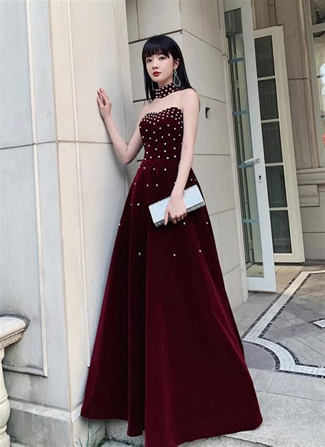 Luxurious Burgundy Velvet Gown With Pearl Embellishments And Choker