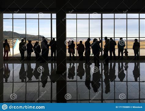 Busy Airport With People Standing Near The Glass Editorial Stock Image