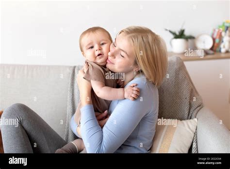 Affectionate Young Mother Cuddling With Her Little Baby Stock Photo Alamy