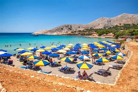 Colorful Sunshades And Loungers In Pondamos Beach At Halki Island In