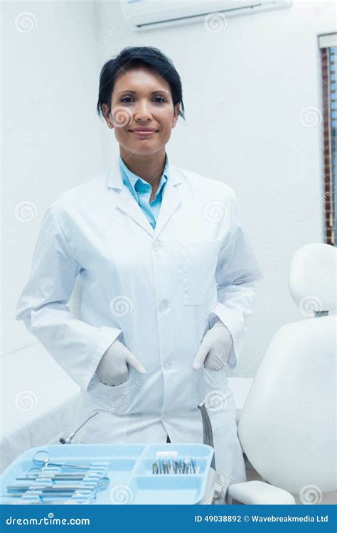 Smiling Female Dentist With Hands In Pockets Stock Photo Image Of