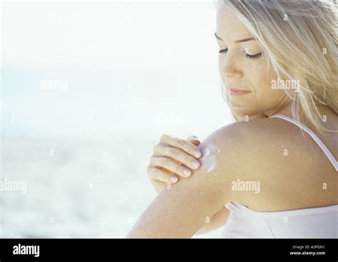 Woman Applying Sun Screen Stock Photo Alamy