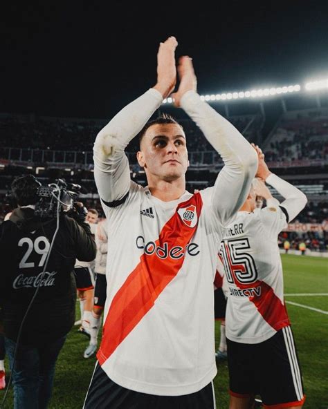 A Soccer Player Holding His Hands Up In The Air