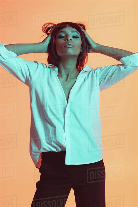 Stylish Young African American Woman Posing With Hands On Head Stock